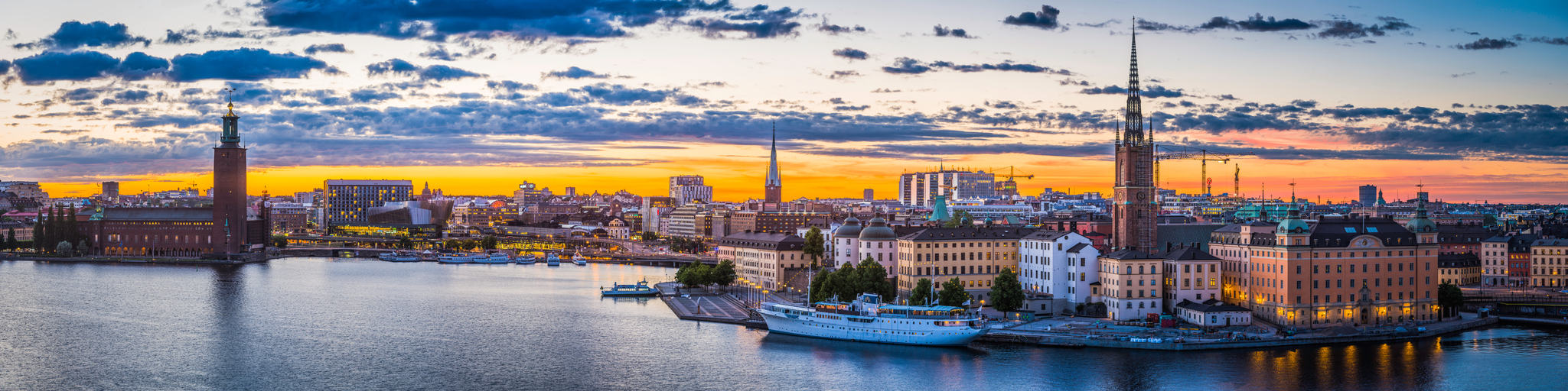 Stockholm sunset spires City Hall illuminated waterfront cityscape panorama Sweden